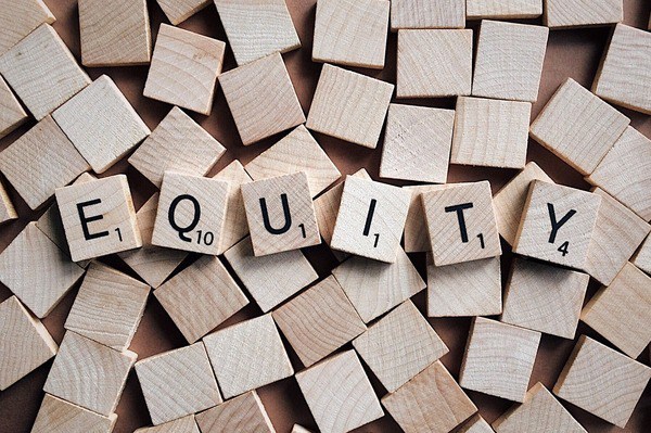Equity spelled out with wooden blocks.