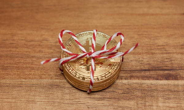 Stack of gold coins with bitcoin symbol on them.