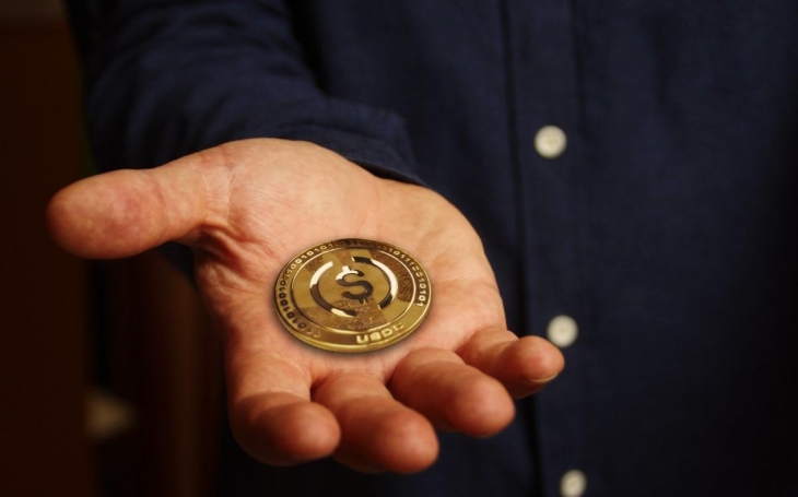 holding a gold coin