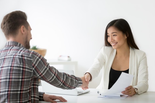 Two business people shaking hands.