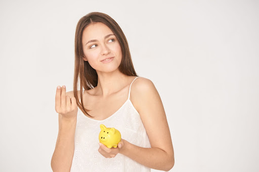 woman holding a piggy bank