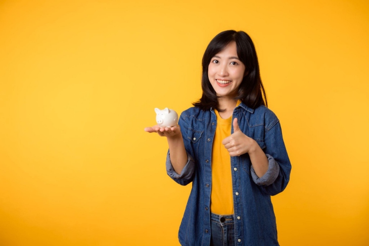 woman holding a piggy bank